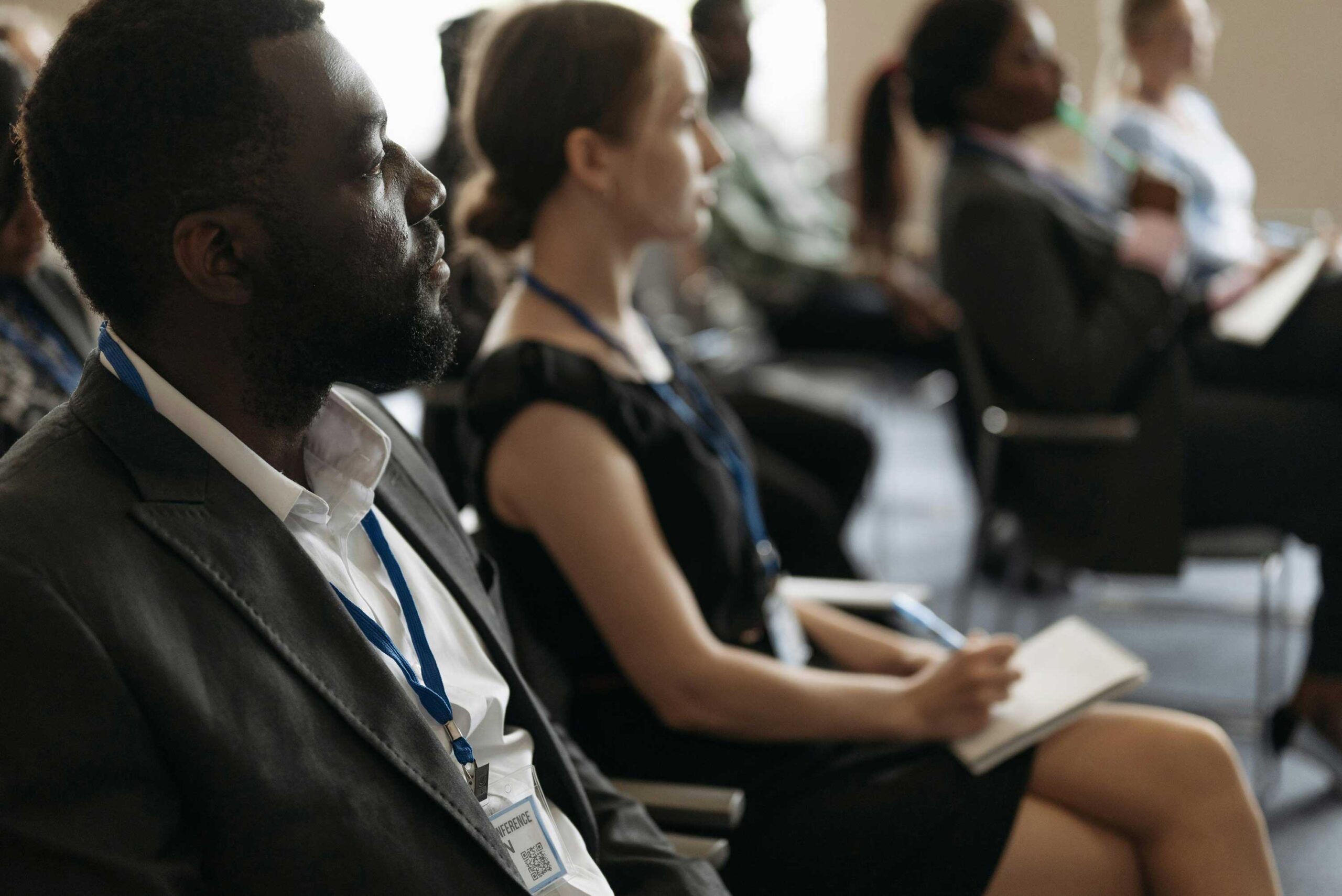 people seated, listening to a speaker