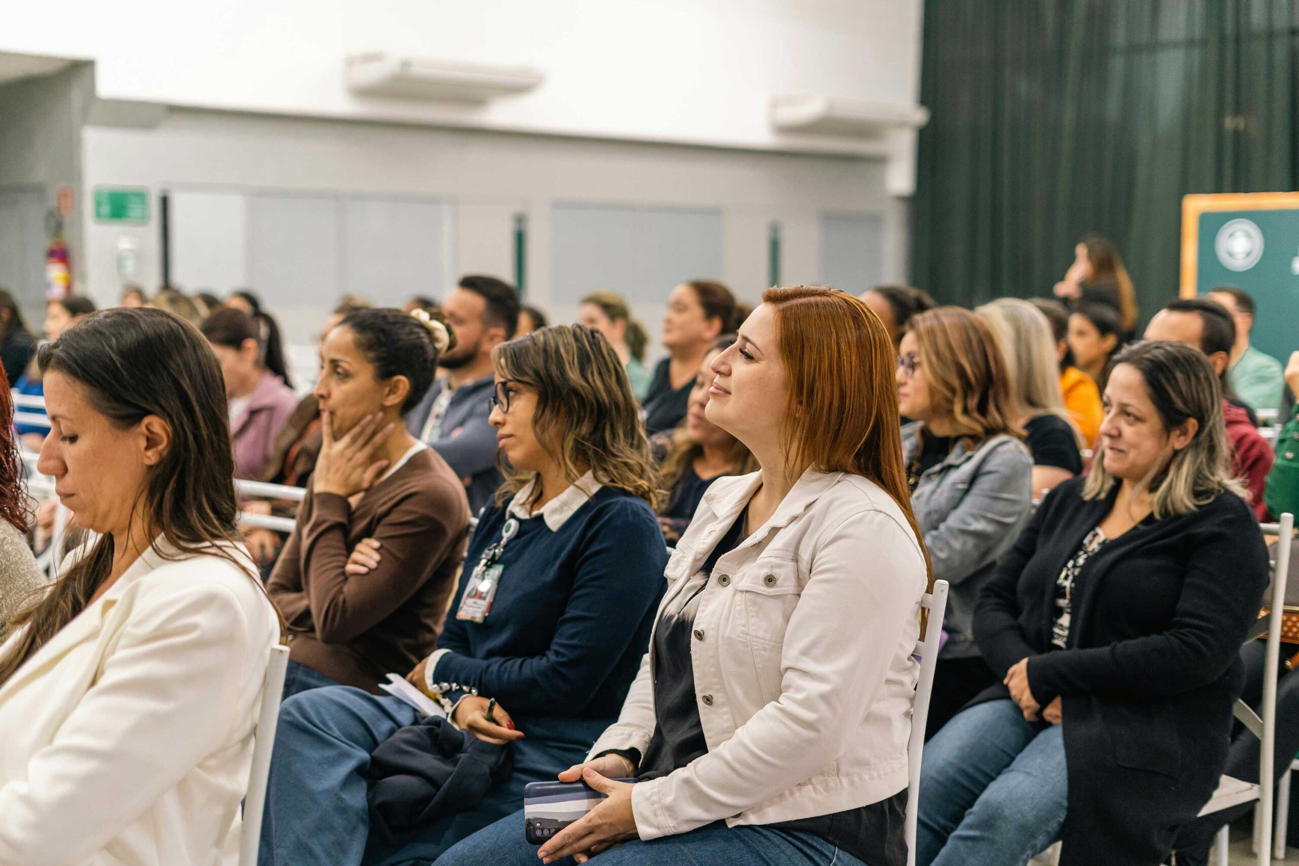 a group of people listening to a speaker
